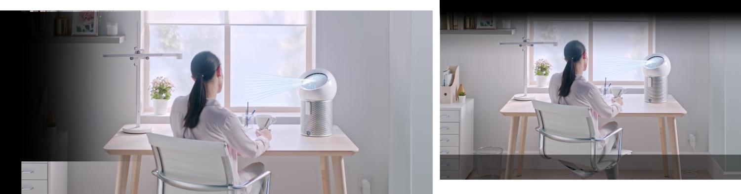 A woman working at a desk in her home while using a Dyson Pure Cool Me purifying fan