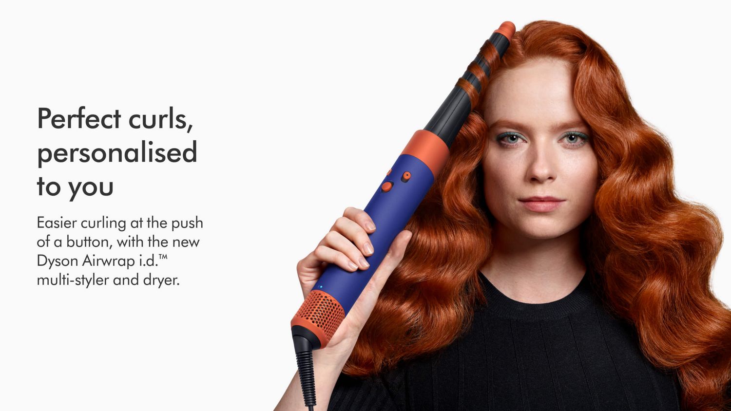 Model using the Dyson Airwrap i.d. multi-styler and dryer to curl a lock of hair.