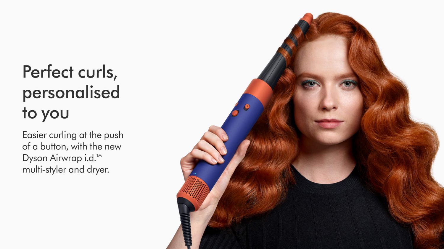 Model using the Dyson Airwrap i.d. multi-styler and dryer to curl a lock of hair.
