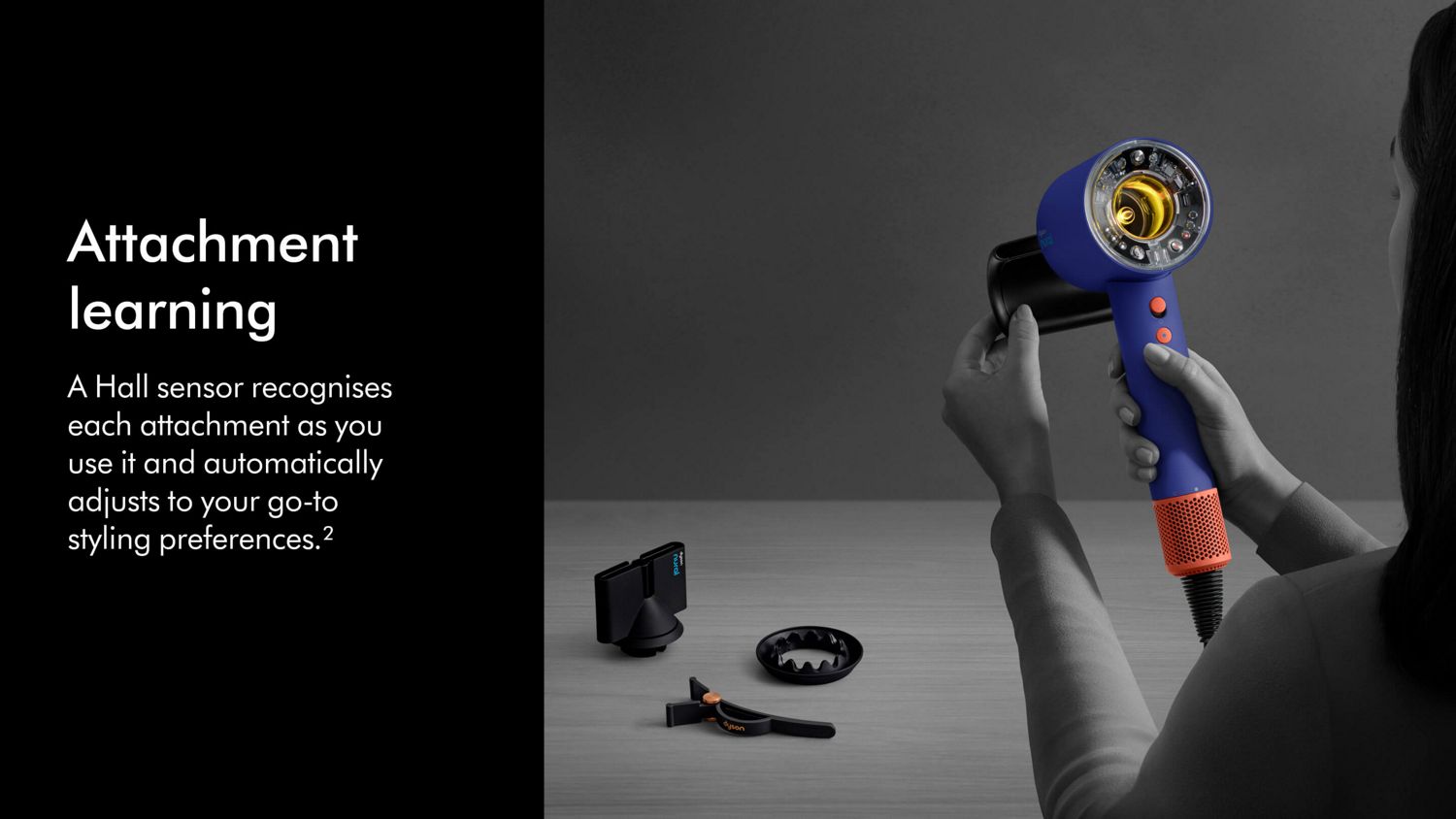 The Dyson Supersonic Nural hair dryer being held in order to attach various Intelligent attachments.