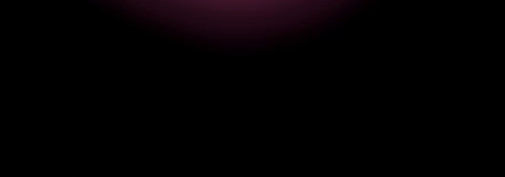 A pink light leak on a black background.