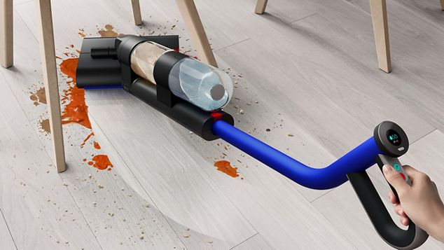 Dyson WashG1 wet floor cleaner removing a red spill from hard floor.