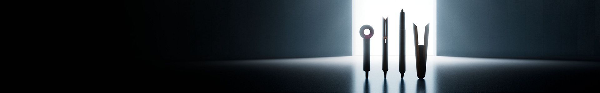 A lineup of sleek Dyson appliances, including hair dryers, multi-stylers and more arranged in a dark room.