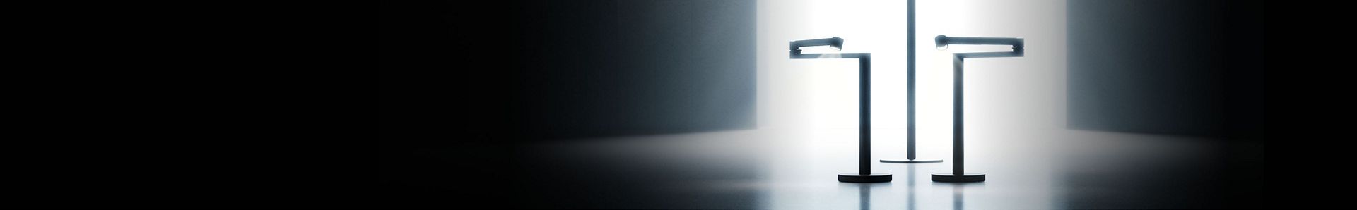 A lineup of sleek Dyson appliances, including vacuums, hair tools, and an air purifier, arranged in a dark room.