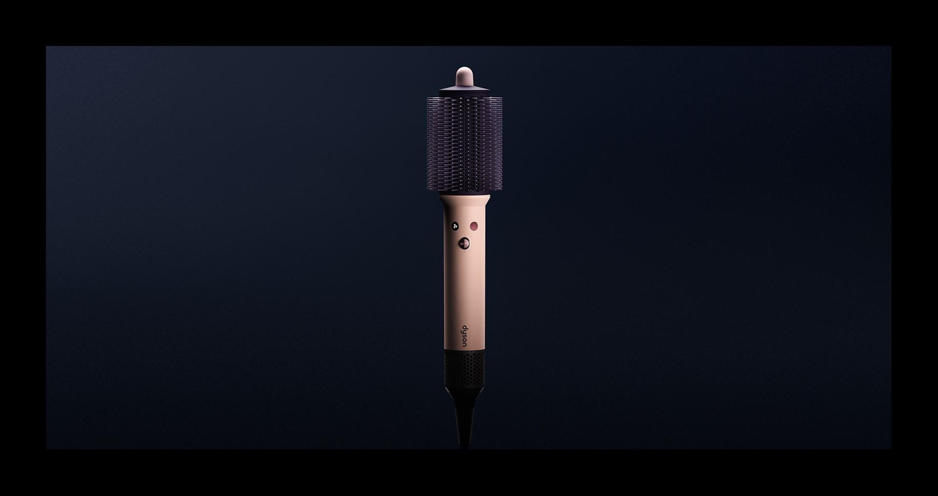 Dyson Airsmooth styling brush on a dark background.