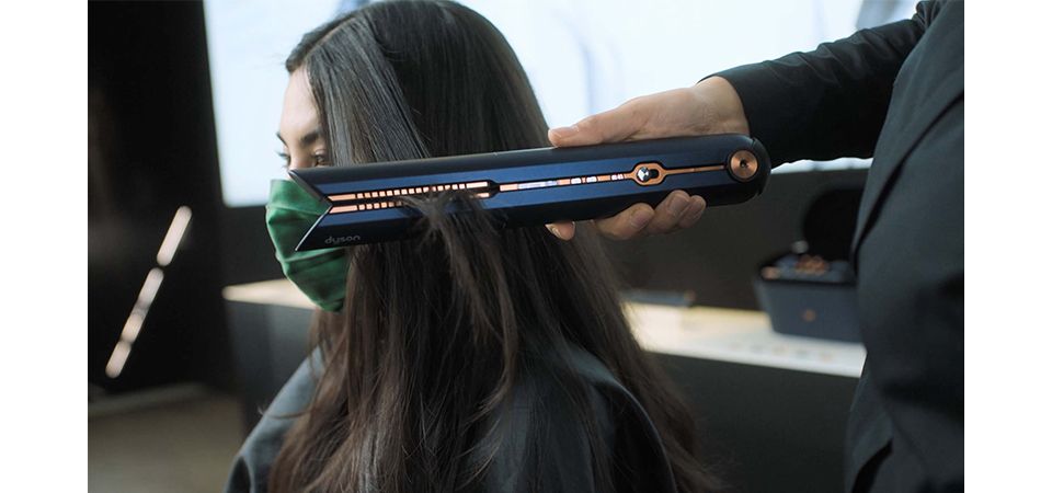 Dyson Expert using Dyson Corrale hair straightener on a client