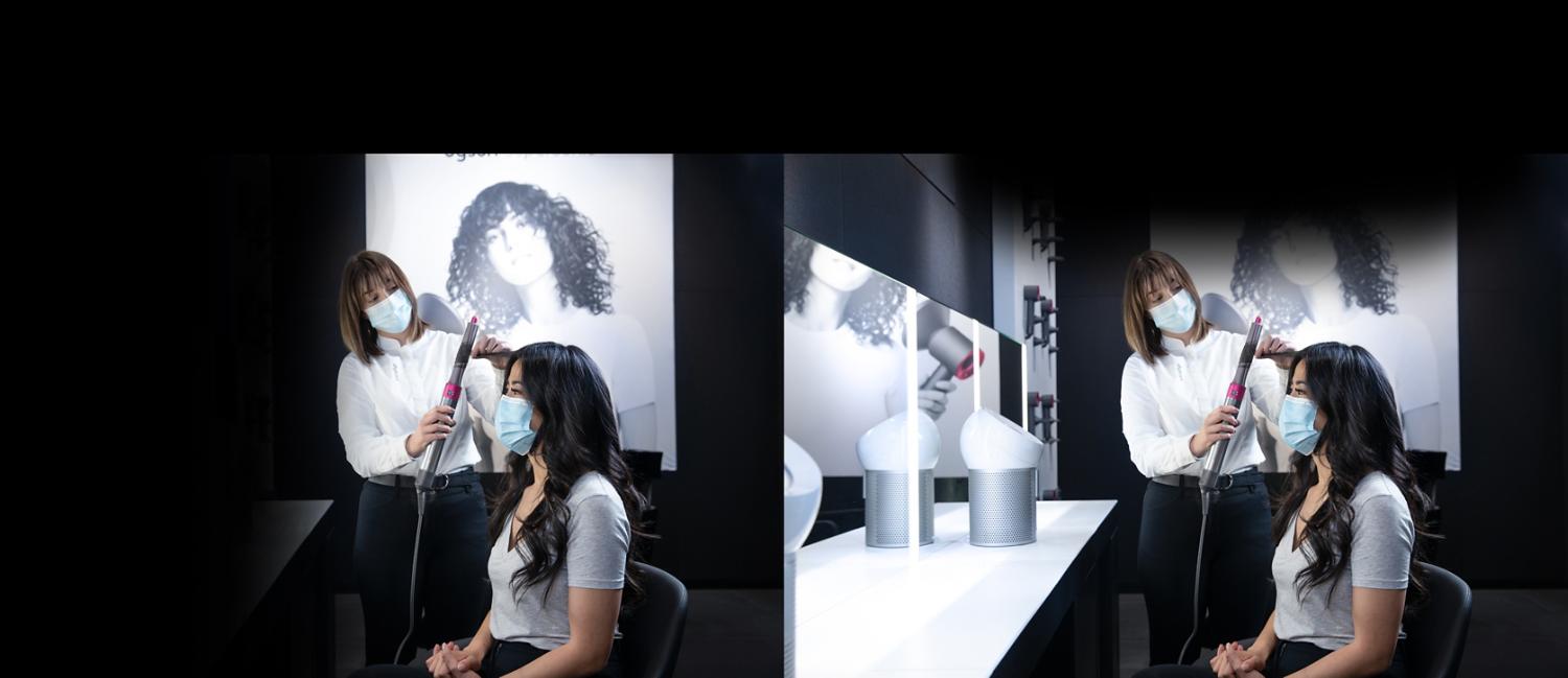 Dyson stylist curling womans hair using the Dyson styler