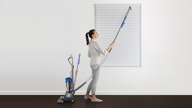 Women using high-reach wand to vacuum blinds