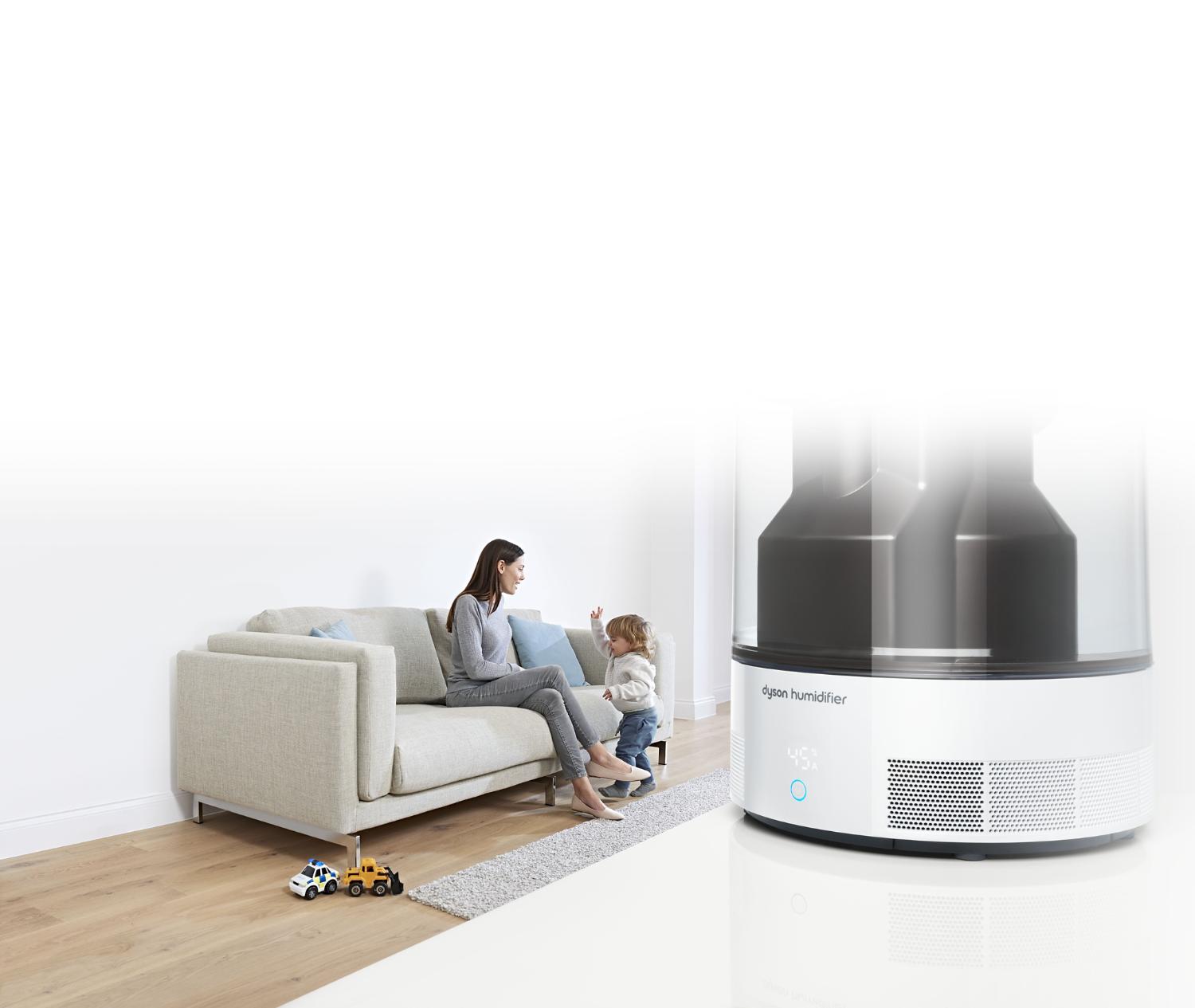 Gros plan sur un humidificateur Dyson, avec mère et son enfant en arrière-plan