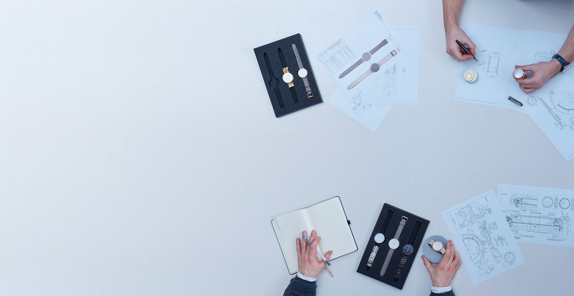Watches and sketches being displayed under Dyson lighting