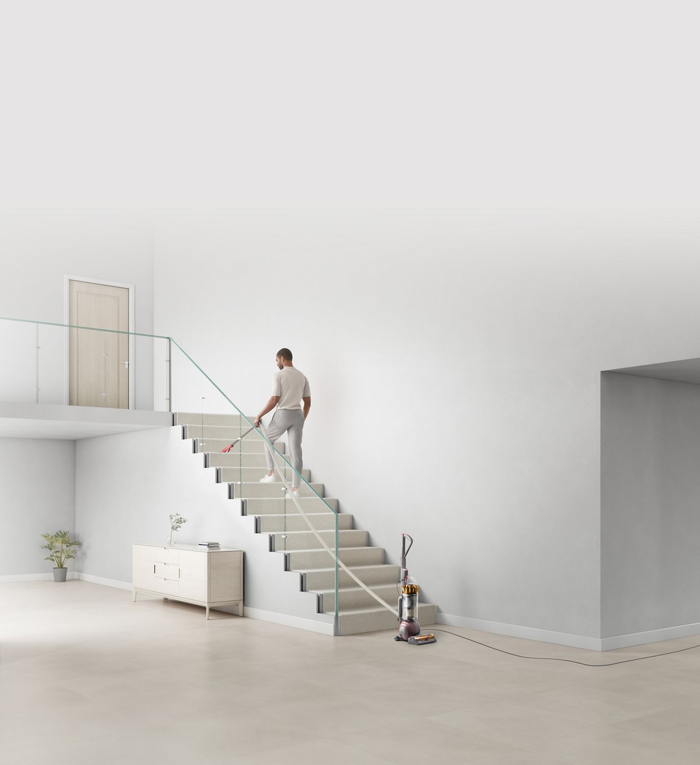 Man cleaning stairs using the extension hose