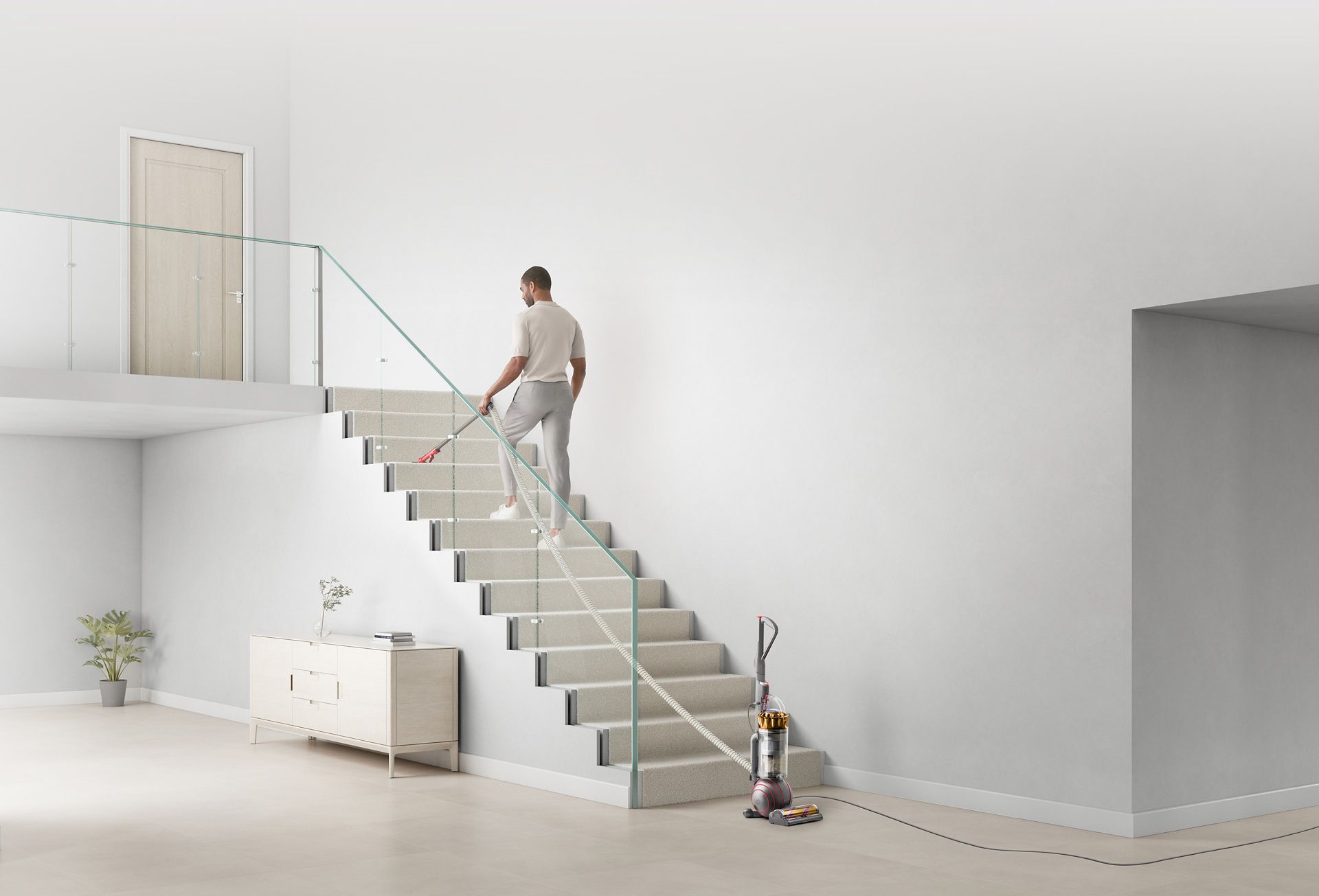 Man cleaning stairs using the extension hose