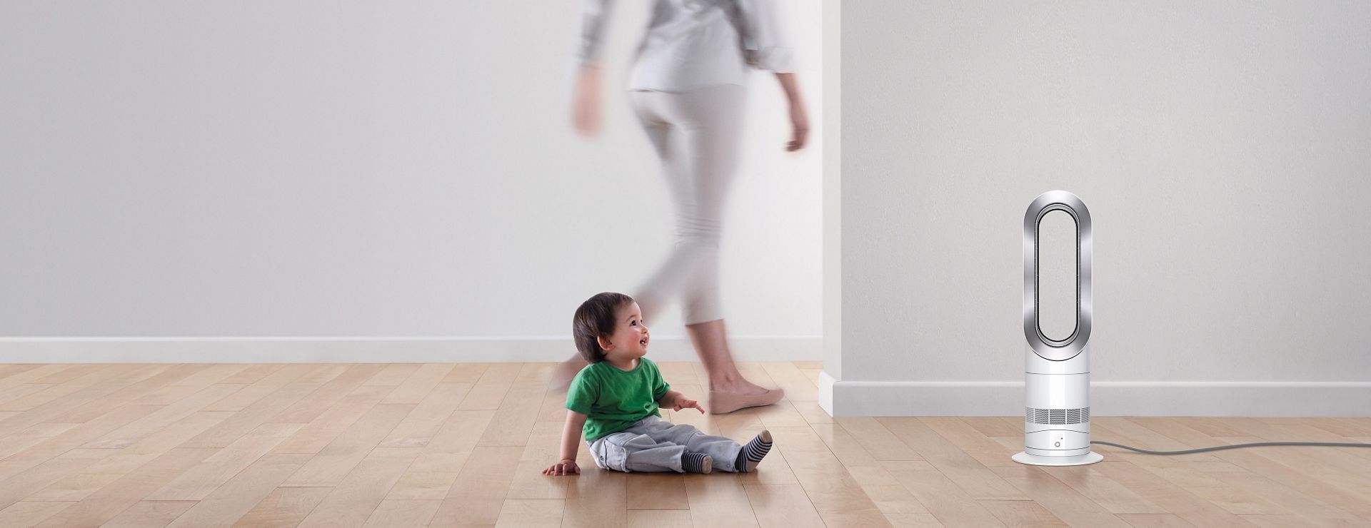 Child playing near Dyson fan heater