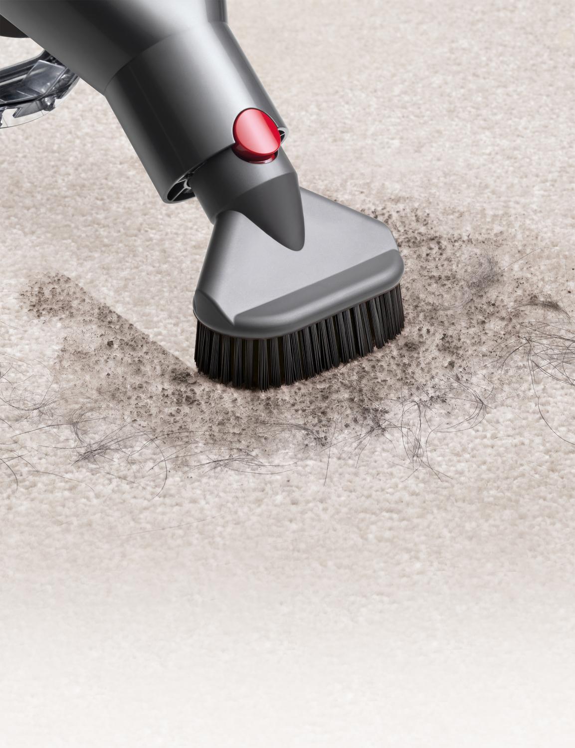 Close-up of Quick-release stubborn dirt brush on carpet