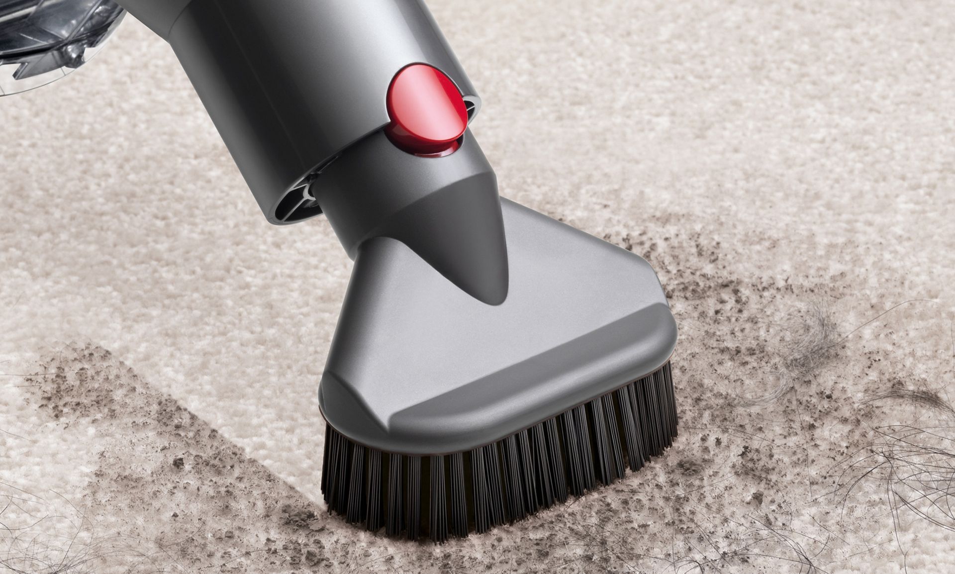 Close-up of Quick-release stubborn dirt brush on carpet