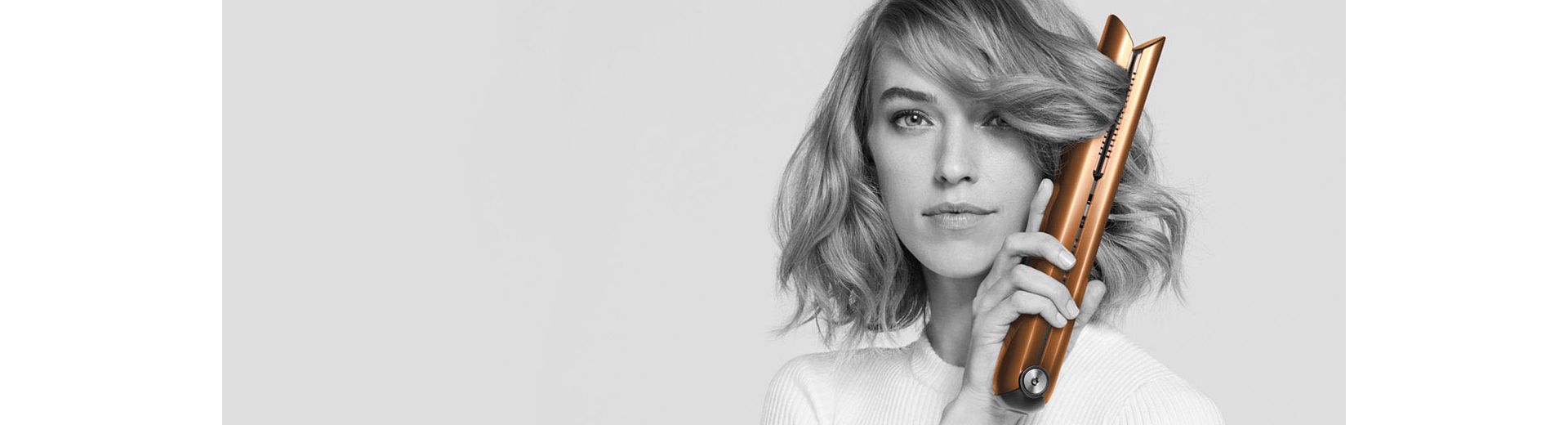 Woman styling hair with the Dyson Corrale straightener