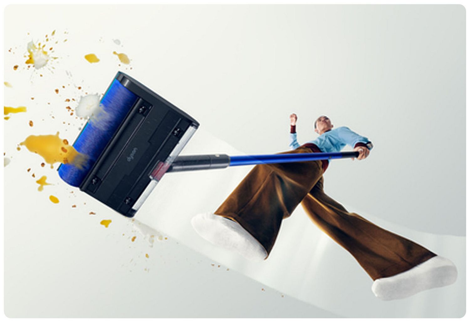 actor using Dyson Pencilwash to clean floor 