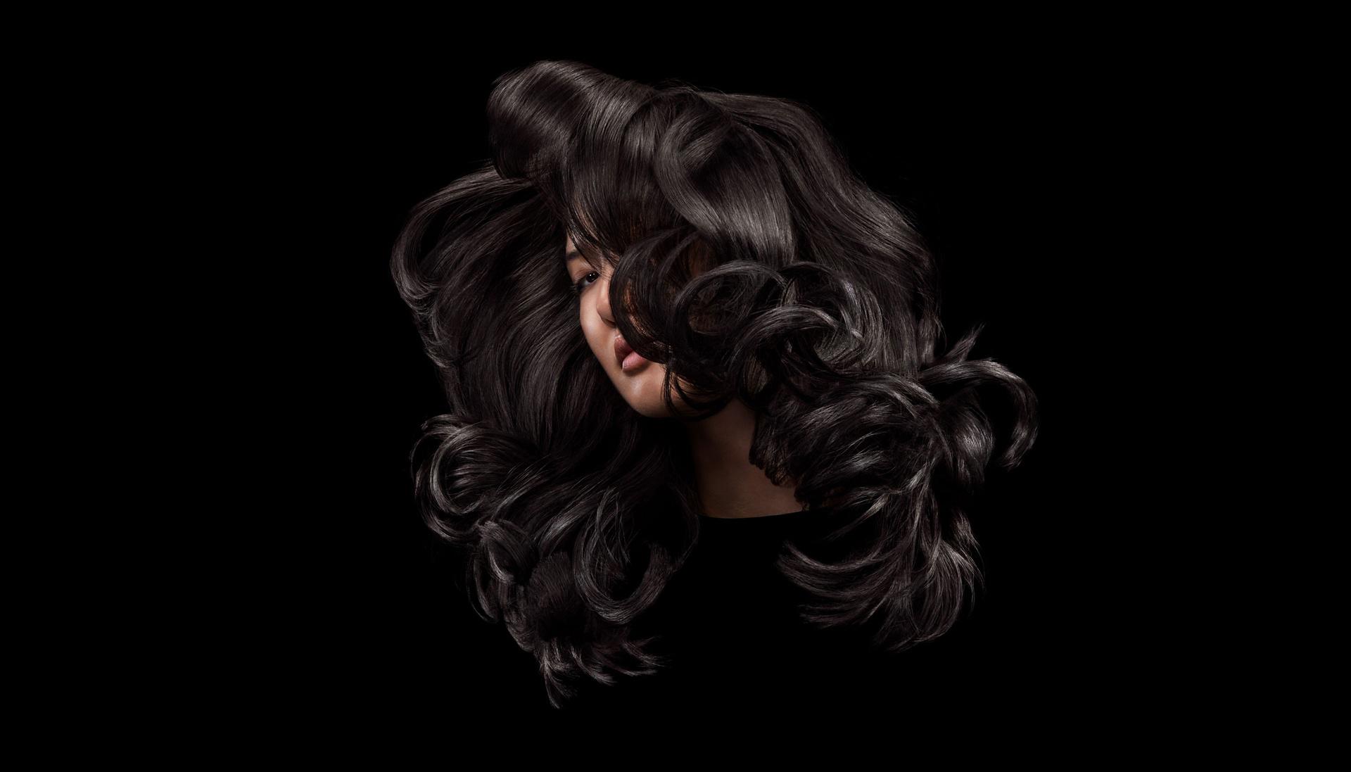 Model with styled curly dark hair