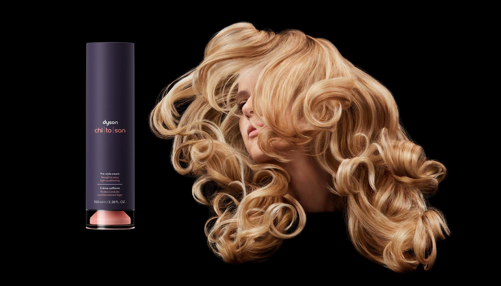 Dyson Chitosan Pre-style cream next to model with curly styled hair on black background