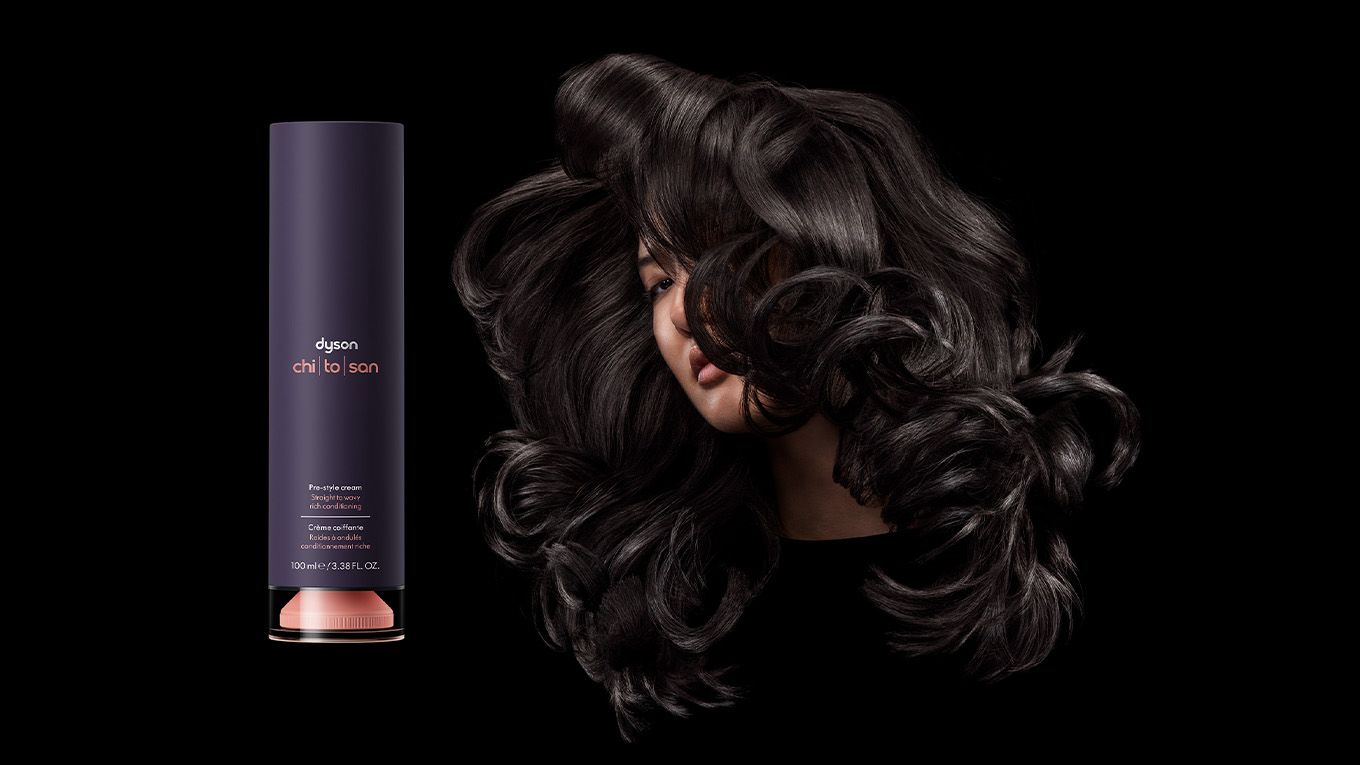a model with dark curled hair next to Dyson Chitosan Pre-style cream