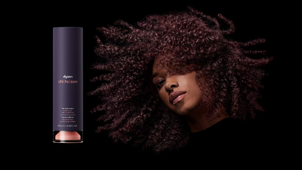 A model with curly coily hair next to the Pre-style cream