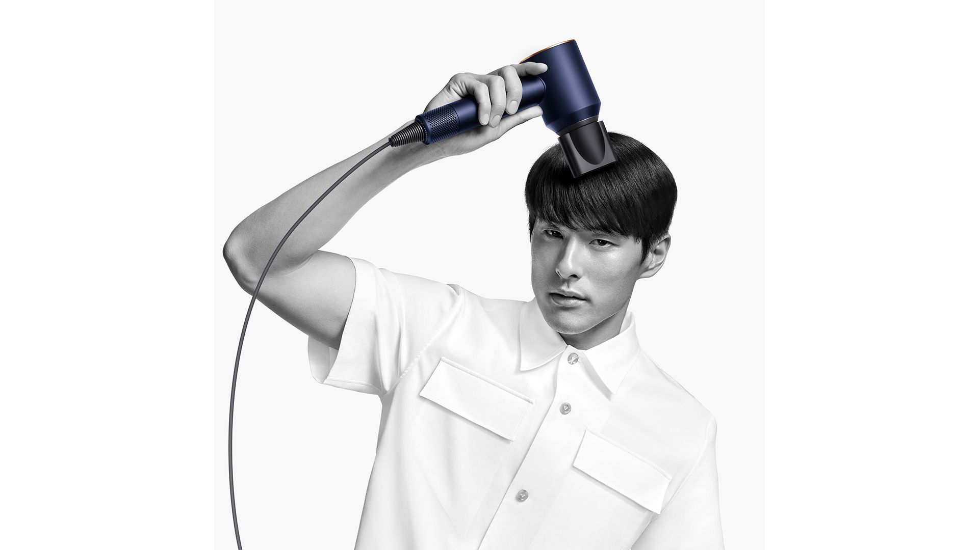 Dyson Supersonic hair dryer with the Smoothing nozzle used by man to smooth his flyaways.