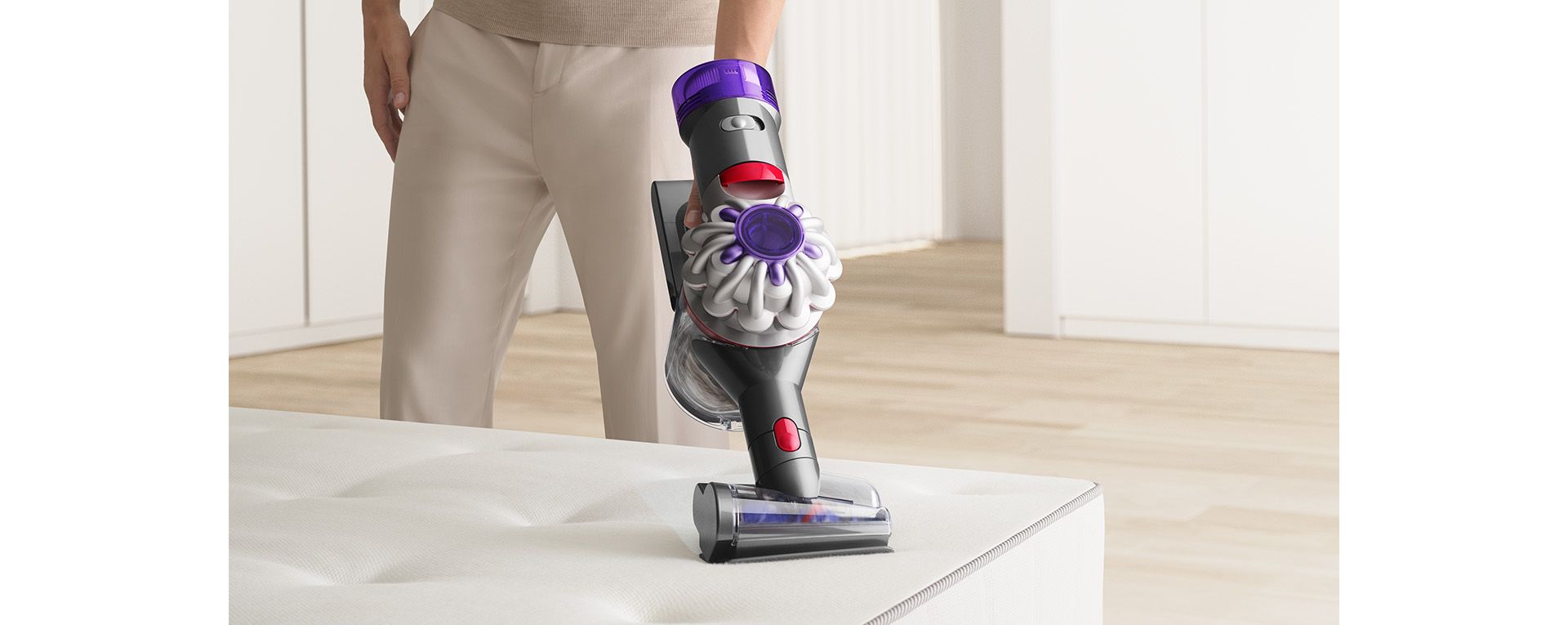 Dyson handheld vacuum vacuuming couch