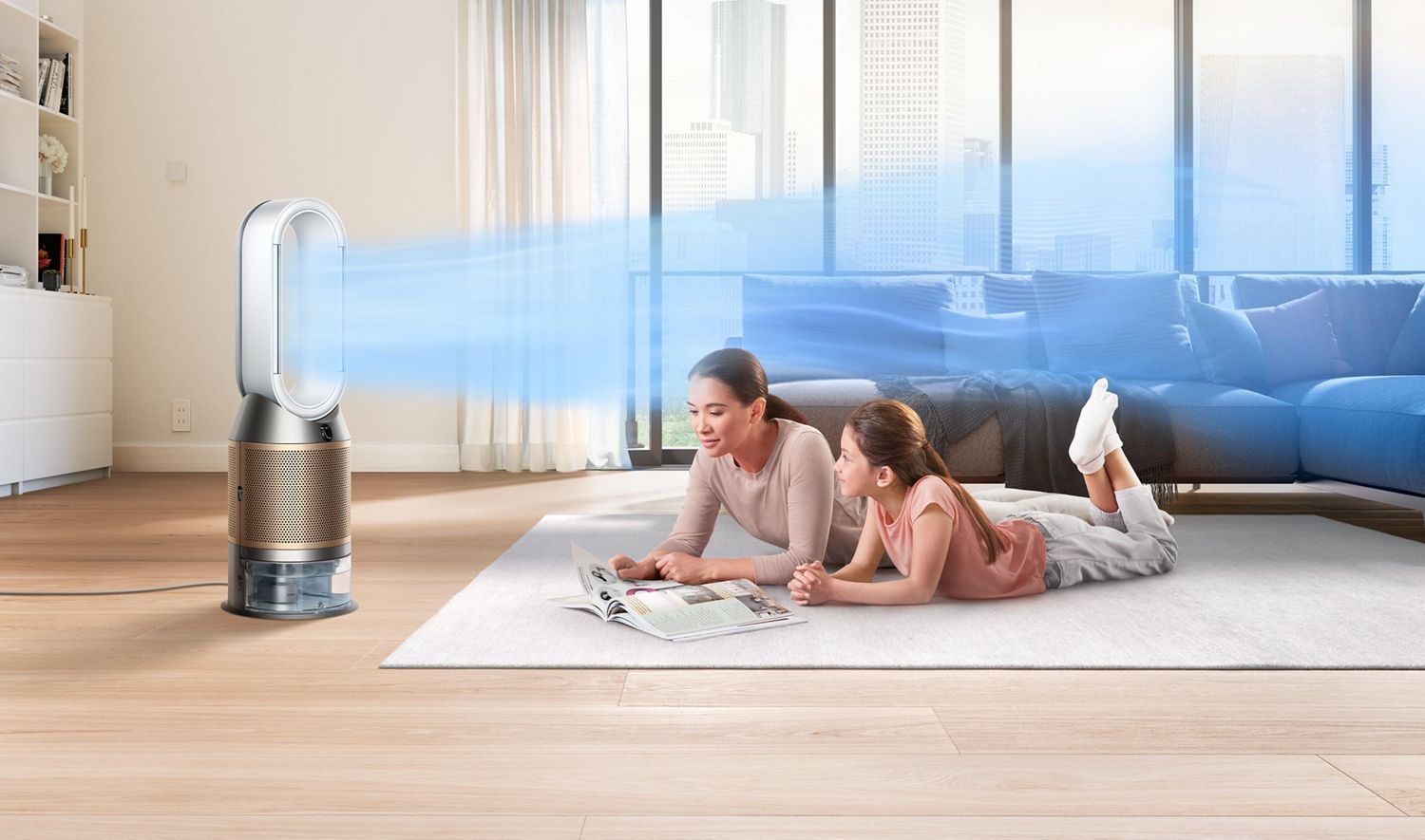 Dyson air purifier circulating cleaner air while mother and daughter lie down reading magazine on living room rug