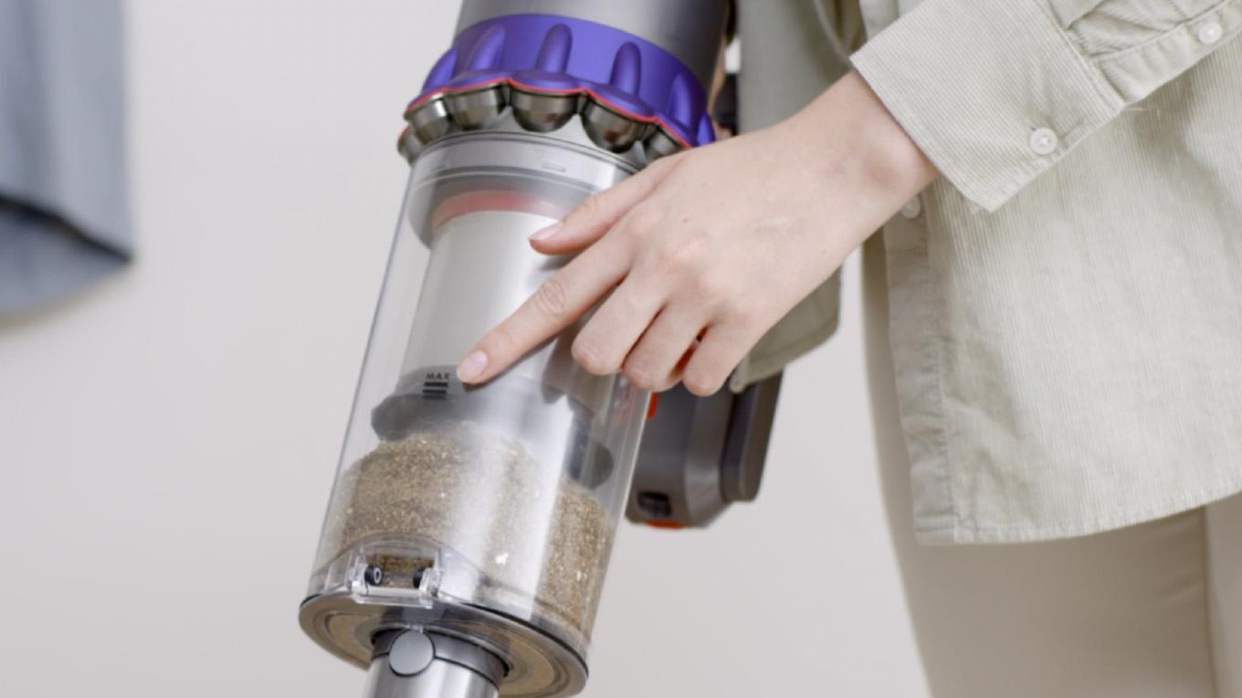 A Dyson owner notices that the dust and debris in their vacuum bin has reached the MAX mark and their machine needs emptying.