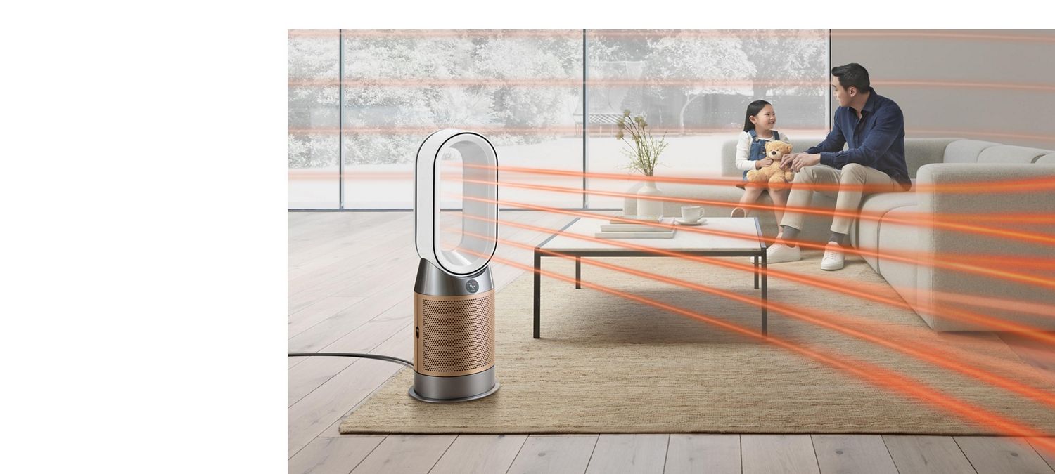 Dyson fan heater used to amplify airflow throughout the room as man and his daughter sit on sofa