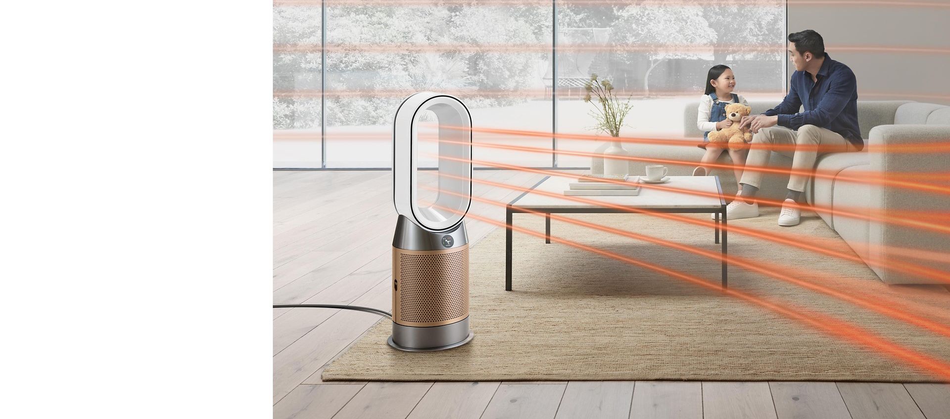 Dyson fan heater used to amplify airflow throughout the room as man and his daughter sit on sofa