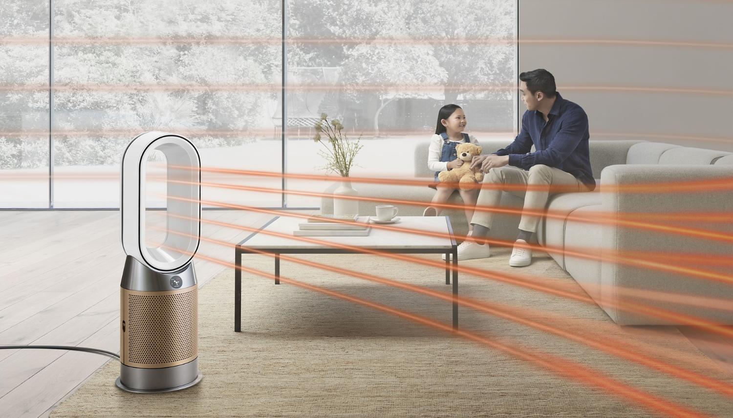 Dyson fan heater used to amplify airflow throughout the room as man and his daughter sit on sofa