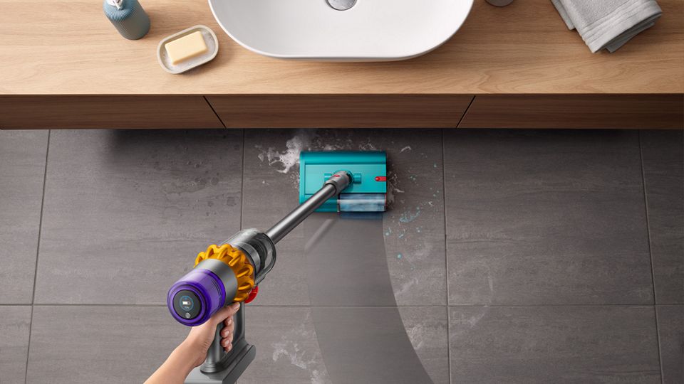 Dyson Submarine wet roller head used to clean bathroom floor by sink