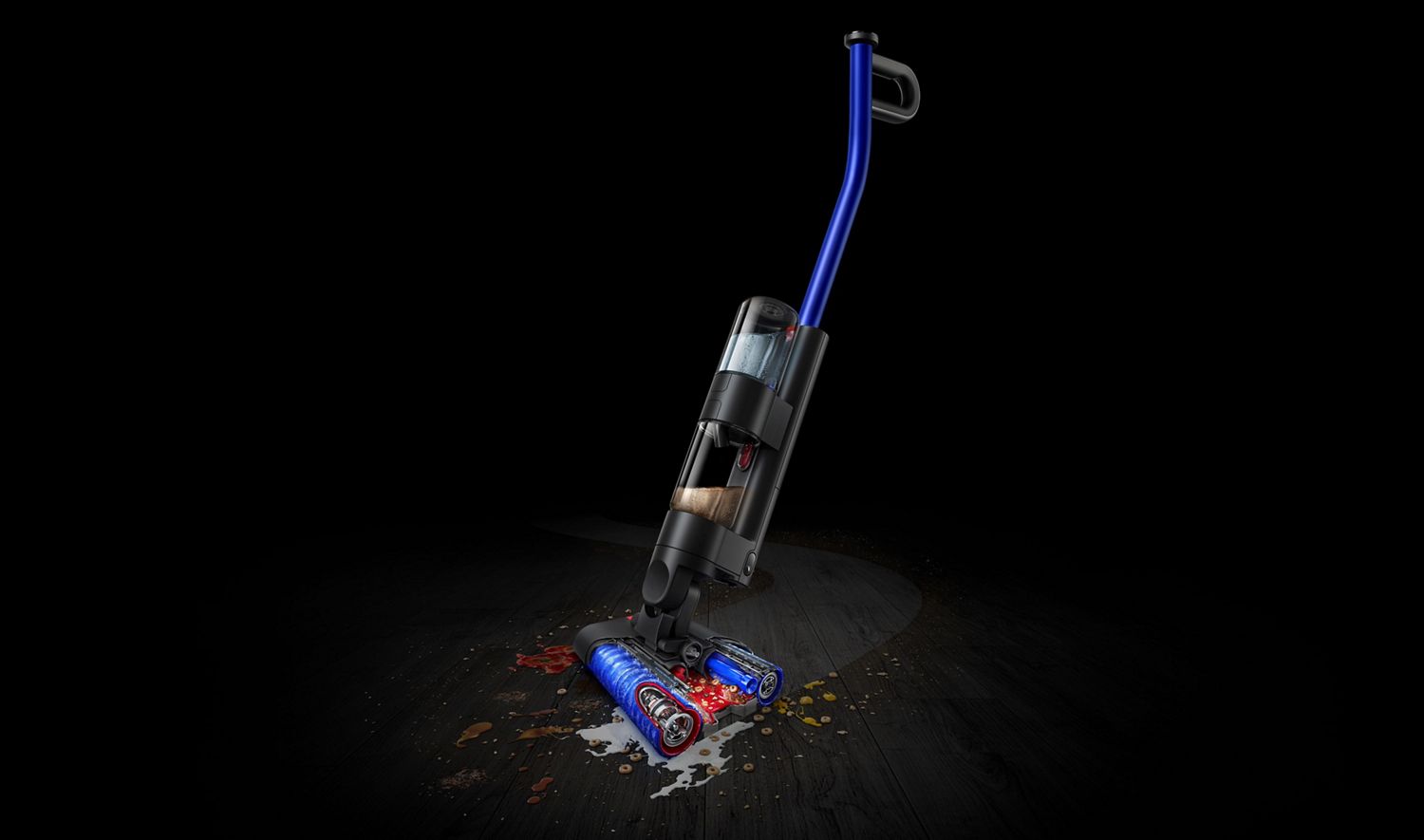 Dyson WashG1 wet cleaner against black background washing spills on black hard floor