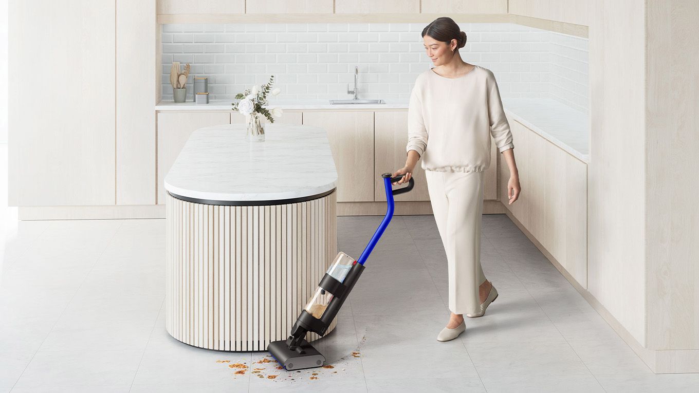 Dyson WashG1 used by woman to clean spills on kitchen floor