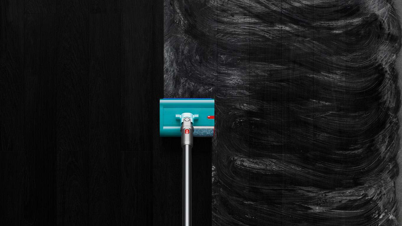 Dyson V15s Detect Submarine washing smeared dirt on black hard floor