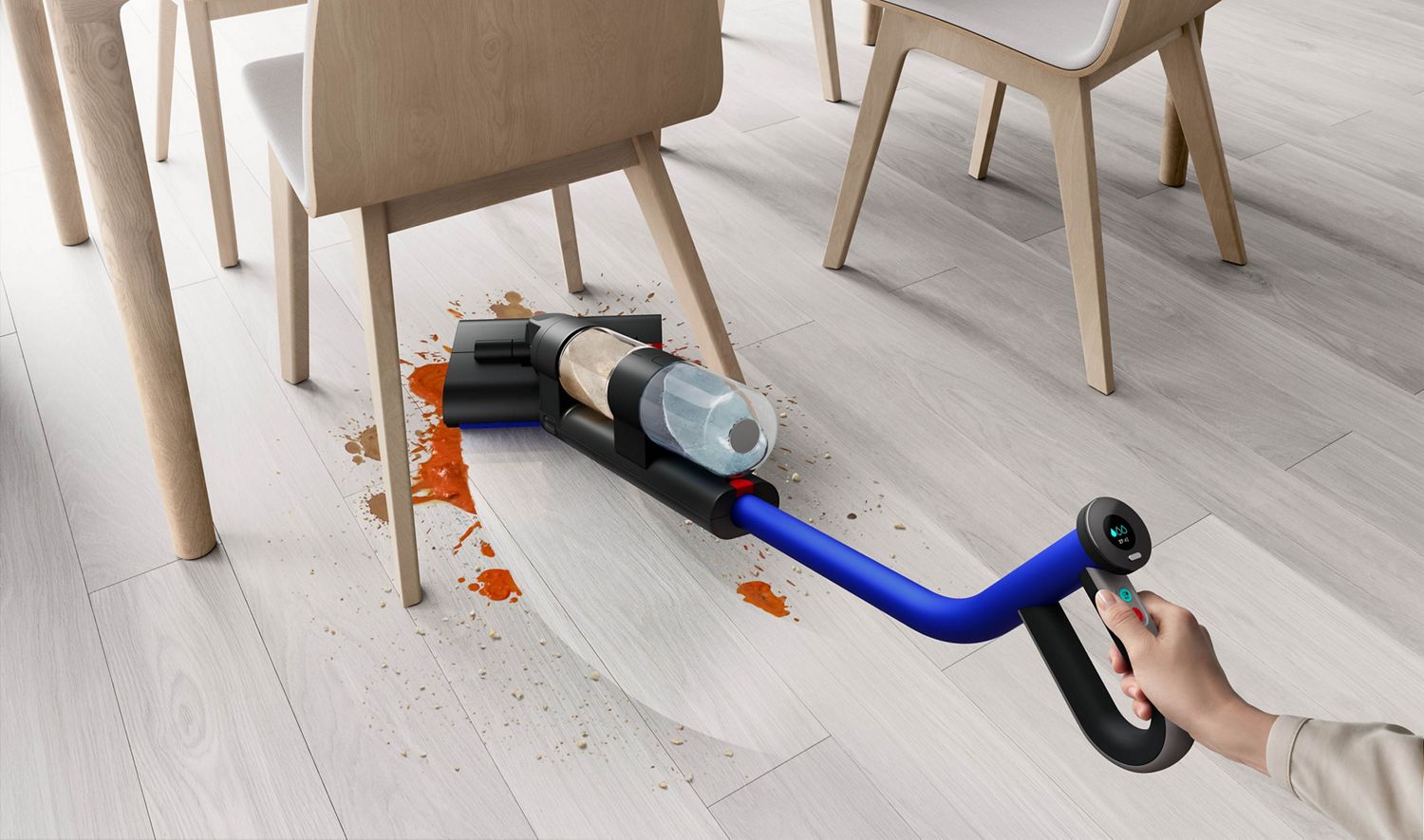 Dyson WashG1 wet cleaner used to wash food spills underneath kitchen chair