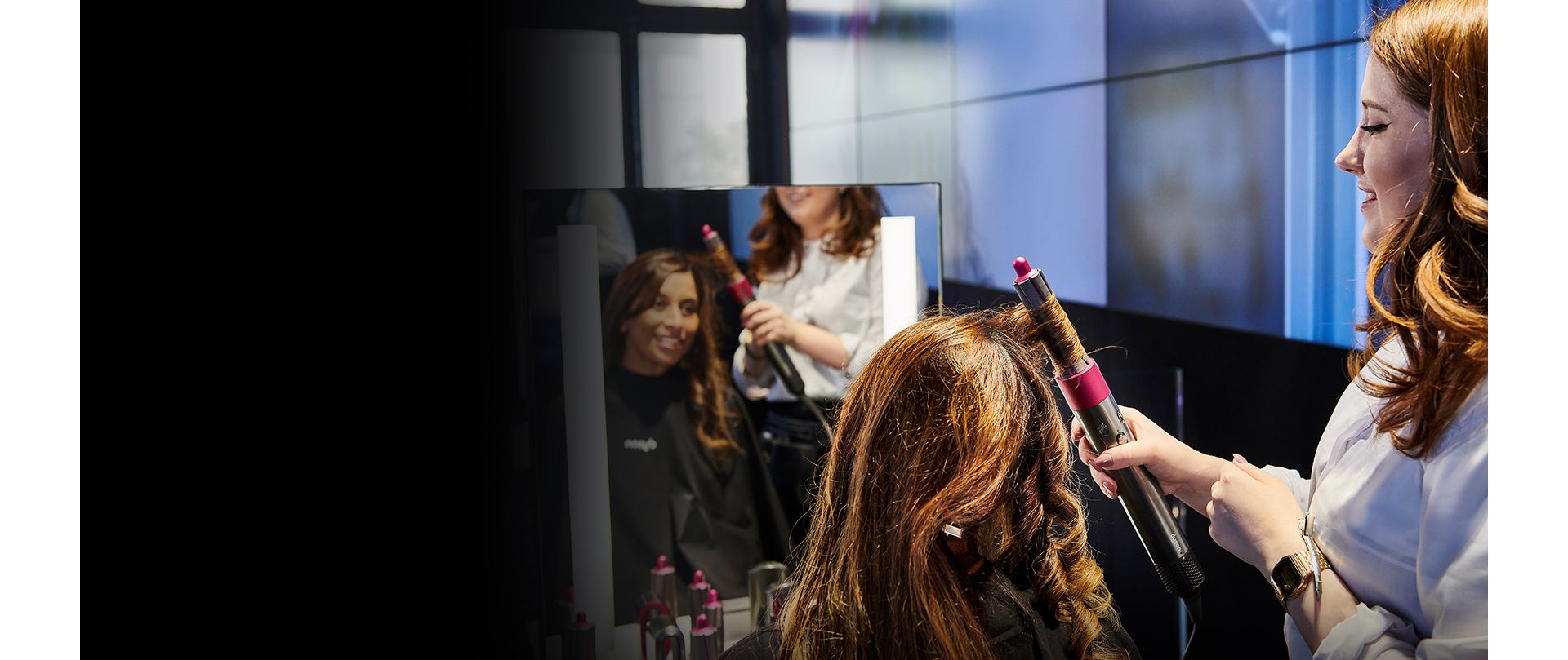 Dyson stylist drying womans hair using the Dyson Supersonic