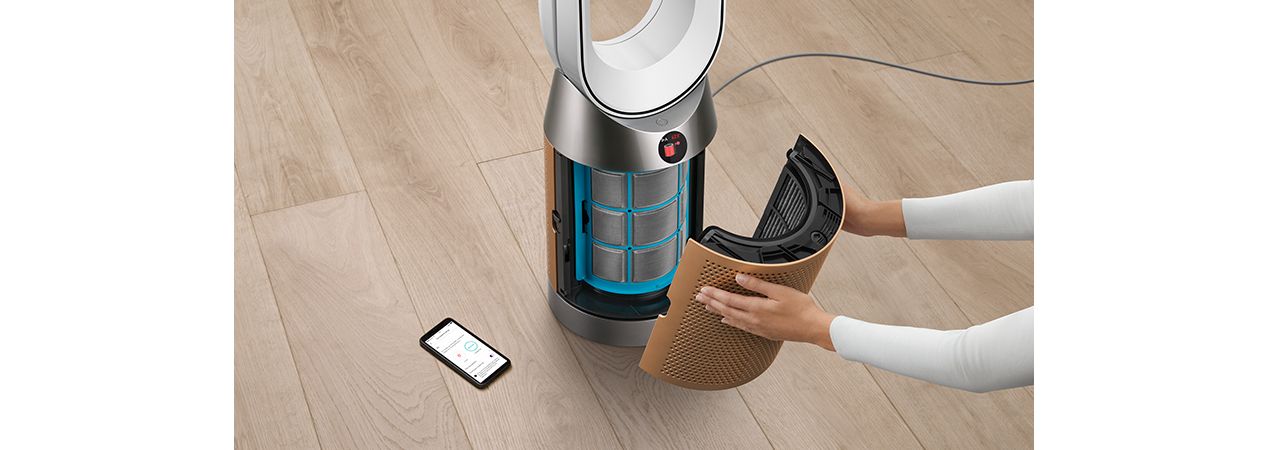 Person changing a Dyson purifier filter
