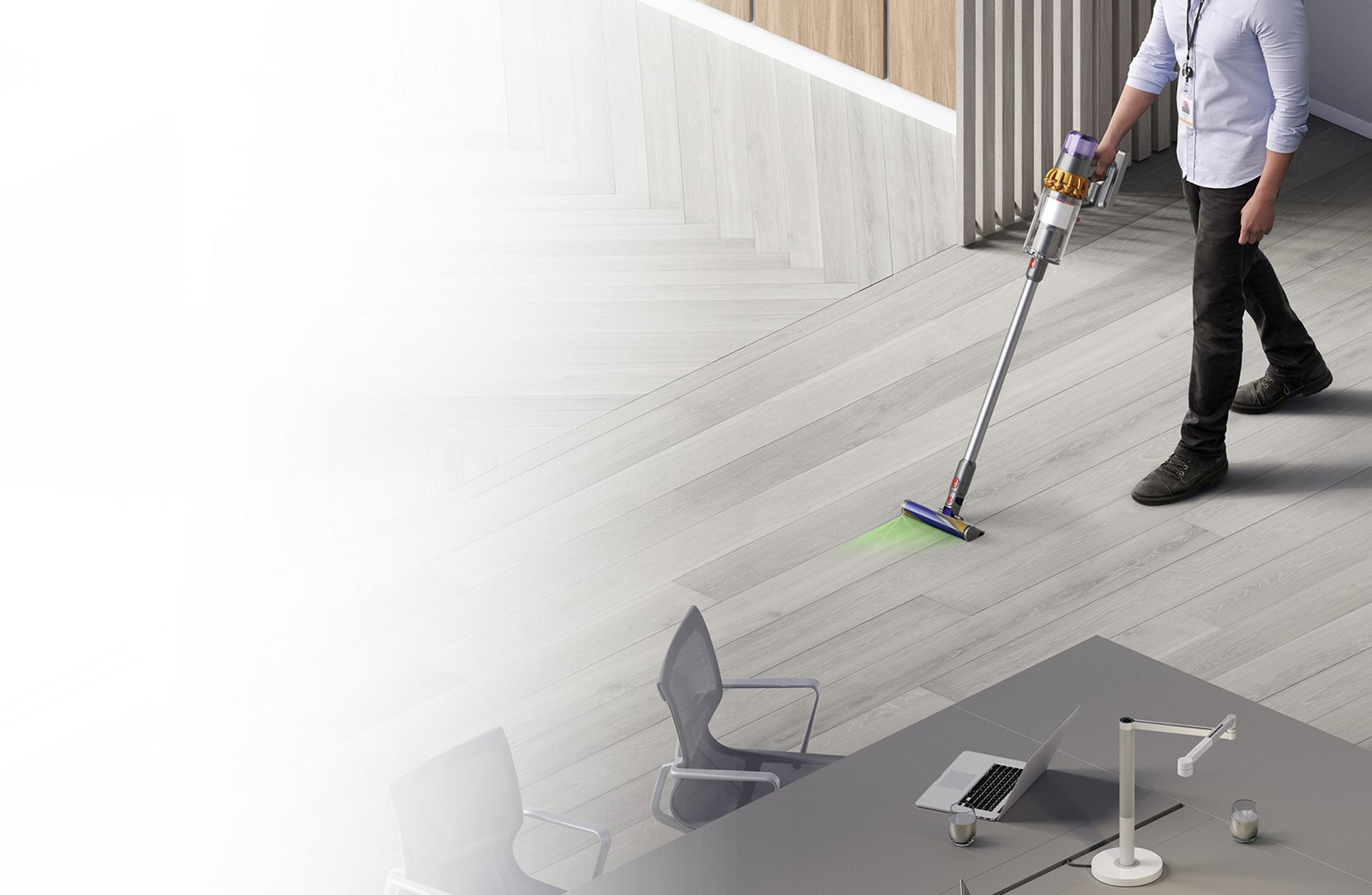 Man cleaning floor with Dyson Detect V15 vacuum