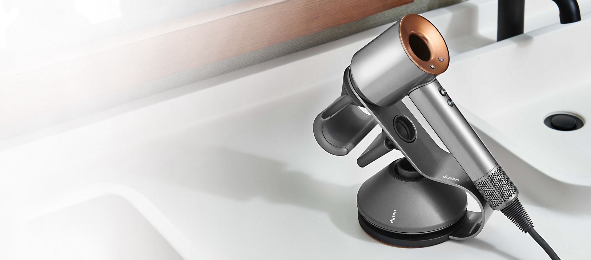 A Dyson Supersonic hair dryer inside a hotel room.