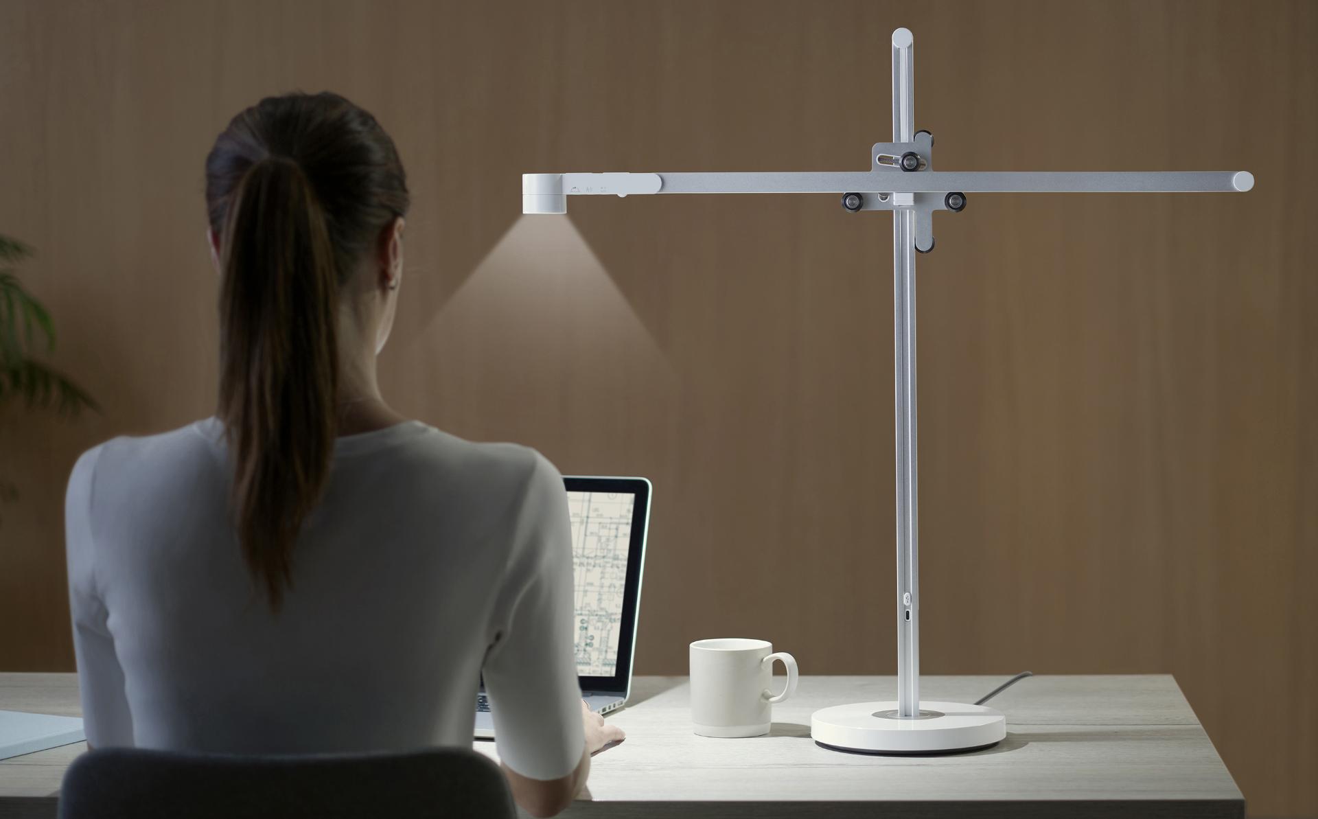 Woman working at desk with Lightcycle task light