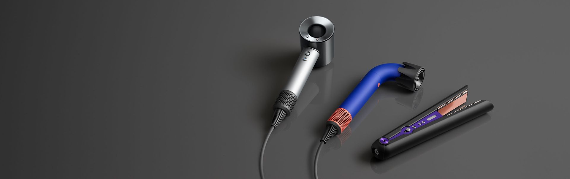 Dyson Supersonic Professional hair dryer next to the Dyson Supersonic r Professional hair dryer and the Dyson Corrale hair straightener for Stylists..