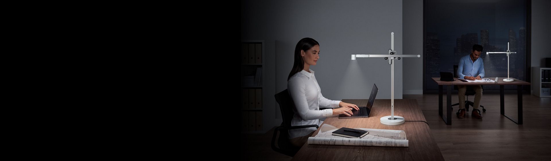 2 people at work using Dyson Lightcycle desk lights