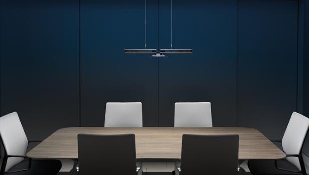 Office desk and chairs under dyson cu-beam down light.