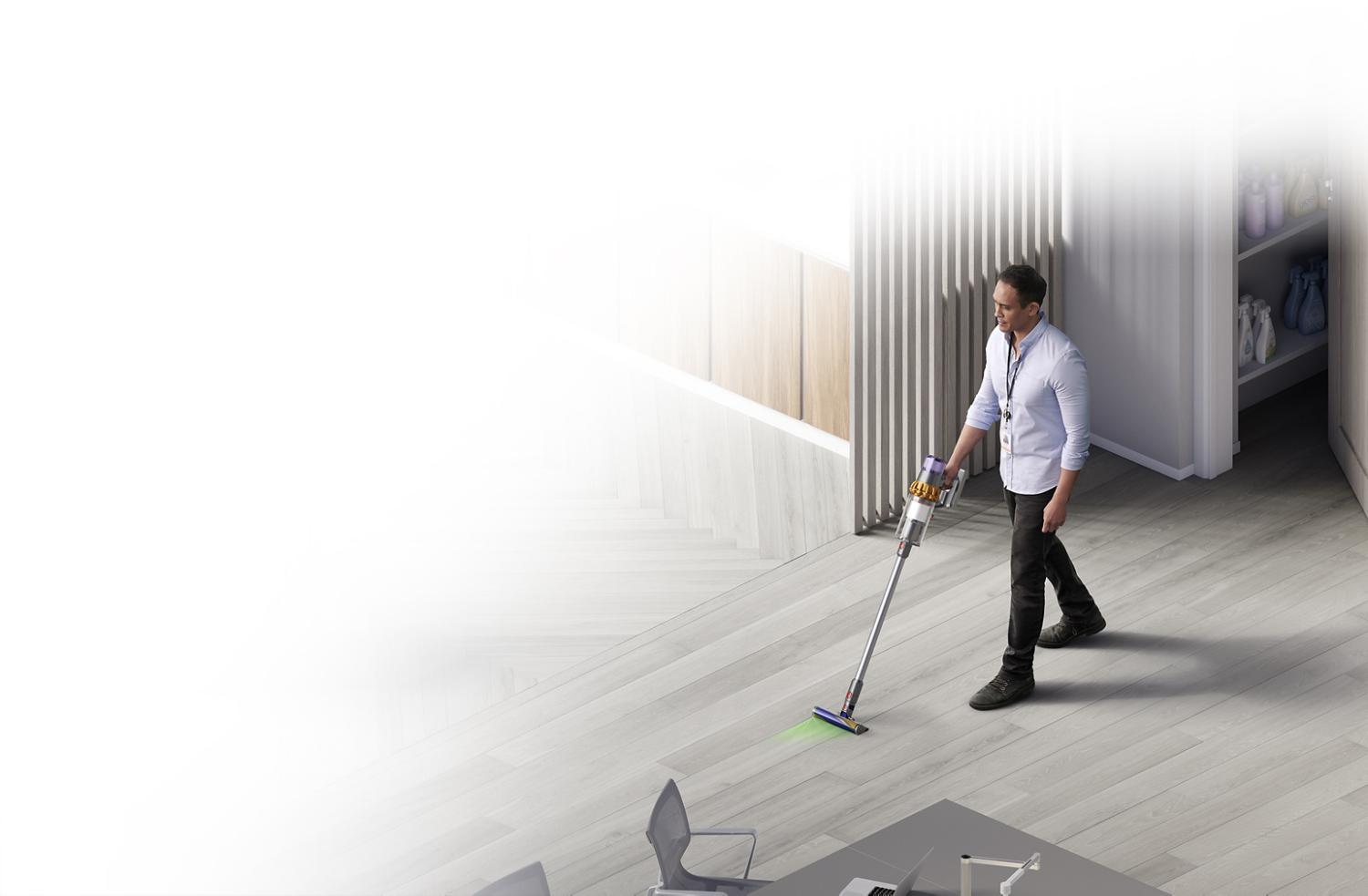 Dyson cordless vacuum cleaner lifting dirt from carpet.