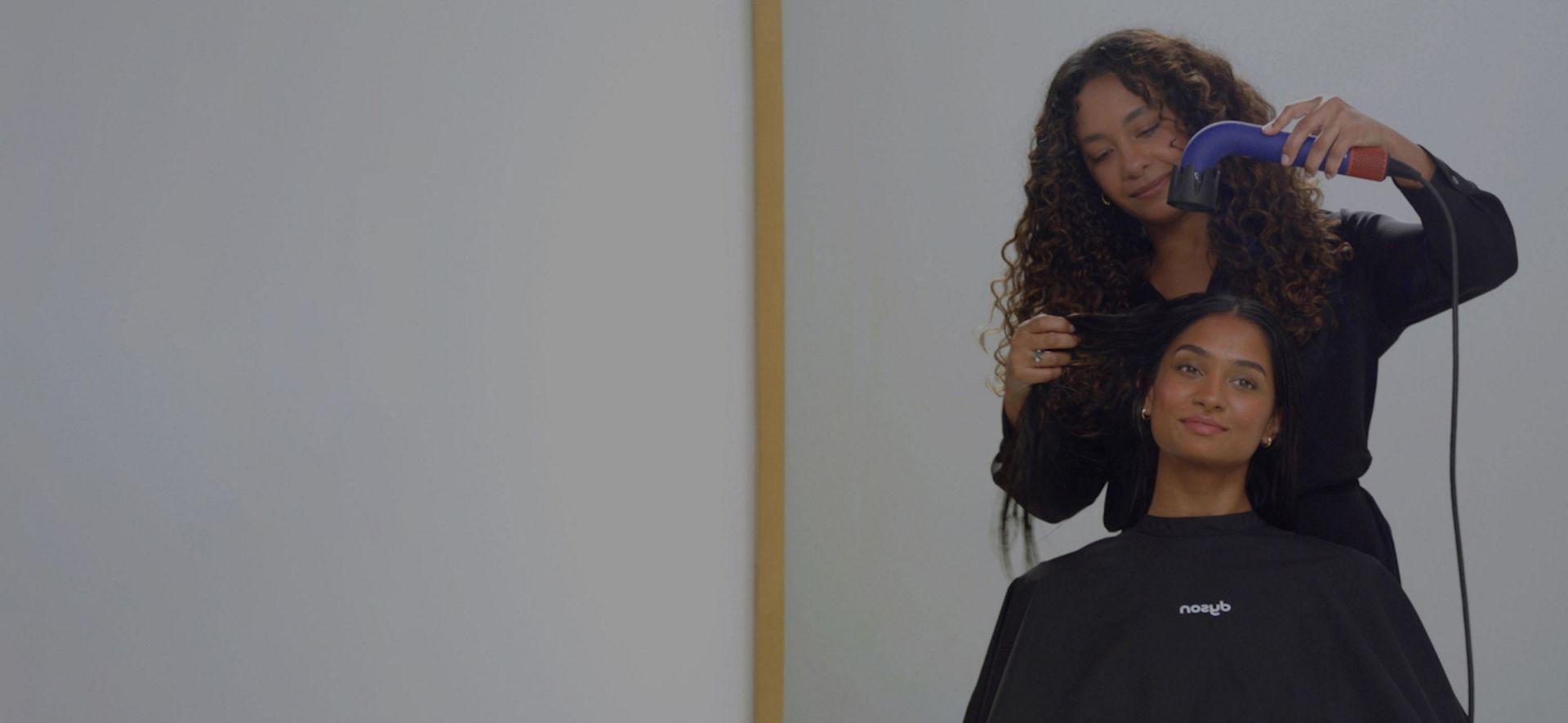 Dyson Supersonic r hair dryer with Powerful air attachment is used on a model to dry hair, before the Pro concentrator is then connected to the machine to smooth the model's hair to finish the style.