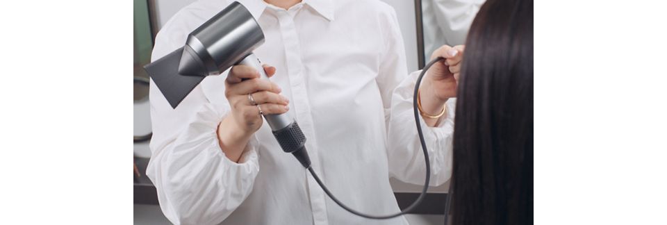 Stylist using the Dyson Supersonic hair dryer Professional