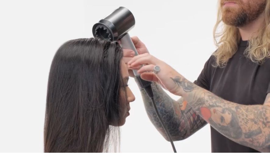 Professional stylist using the Dyson Supersonic professional dryer