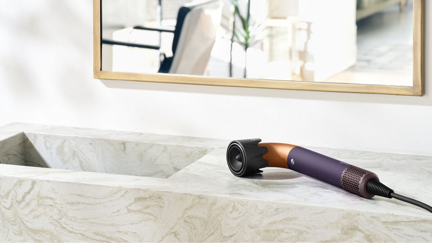 The Dyson Supersonic r Professional hair dryer in Bright copper on a counter.